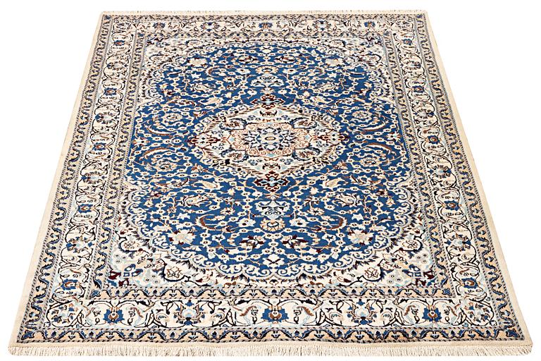 A Nain carpet, part silk, 9 laa, c. 300 x 189 cm.