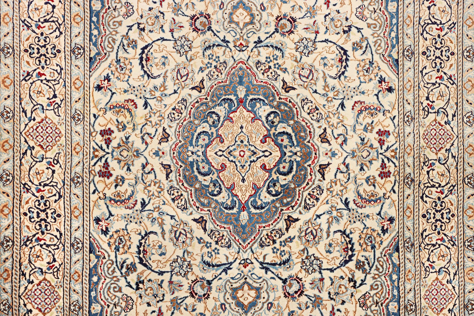A Nain carpet, part silk, 9 laa, c. 300 x 195 cm.