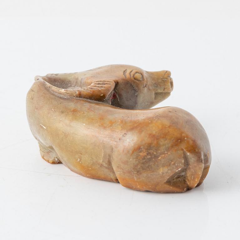 A carved Chinese sculpture of a reclining ox, 20th Century or older.