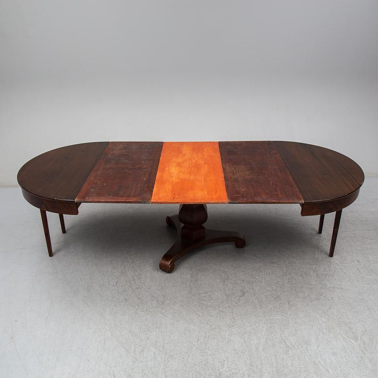 a mid 1800's mahogany dining table with three leaves.