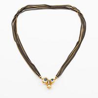 An Ole Lynggaard clasp in 18K gold with aquamarines and a round brilliant-cut diamond, design by Charlotte Lynggaard.
