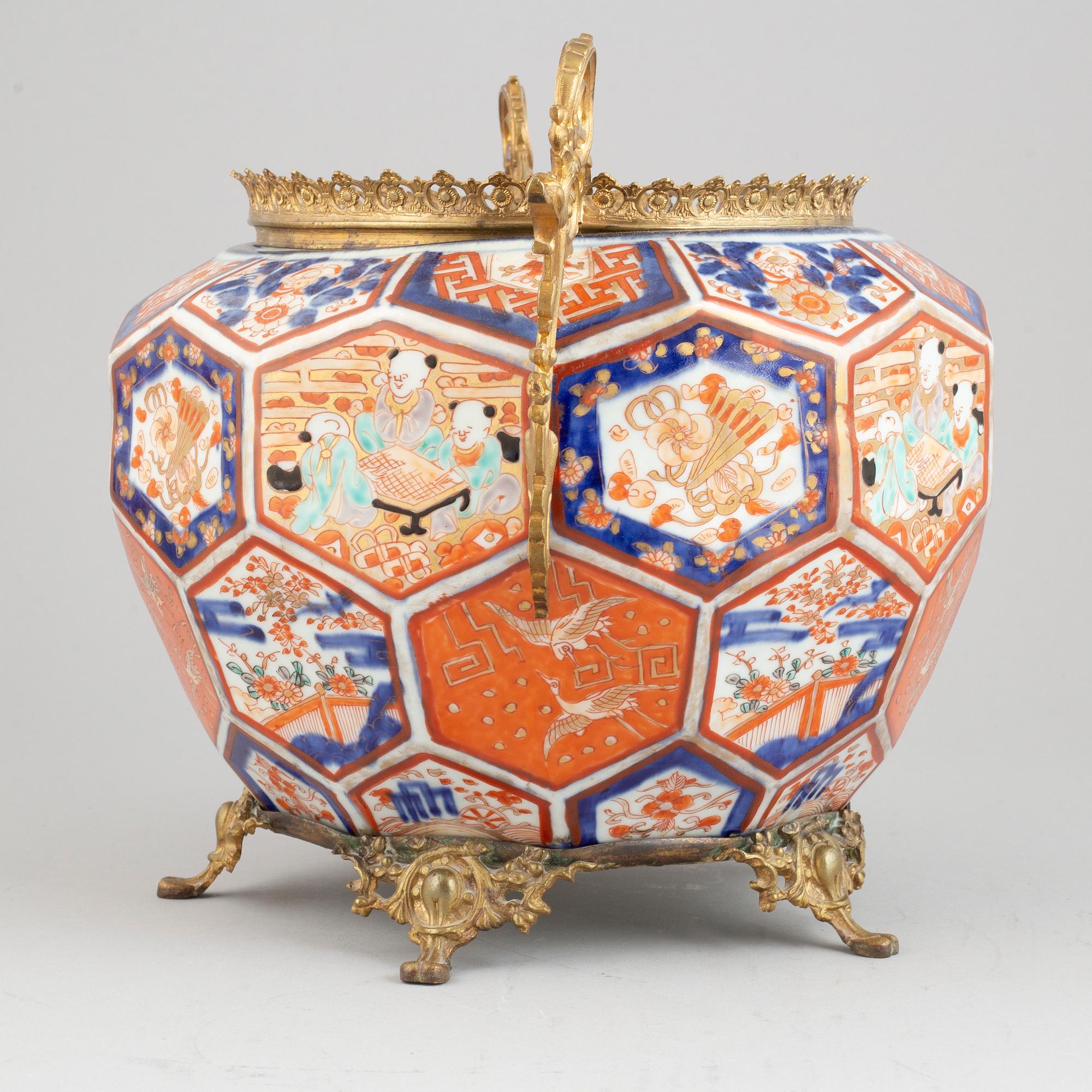 A Japanese plant pot with brass mounts, late 19th century.