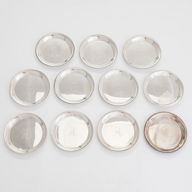 A 21-piece set of 'Chippendale' silver cutlery, and 11 silver coaster, Turku and Hämeenlinna, 1983-90 and 1964.