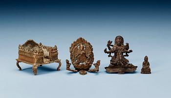 A set of three bronze figures of Buddha and a throne, India, 17/18th Century.