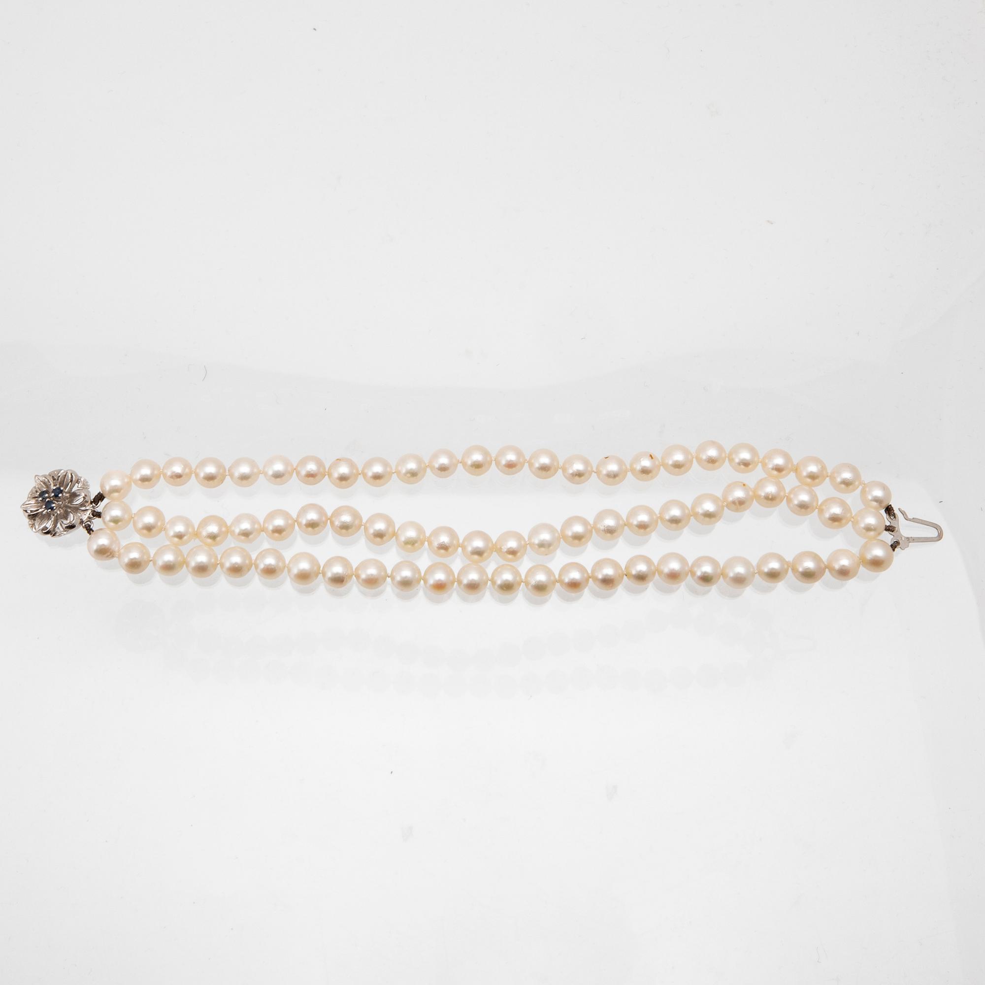 A three-row bracelet of cultured pearls and clasp in 18K white gold.