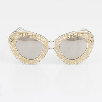 Karen Walker, a pair of "Intergalactic" sunglasses.