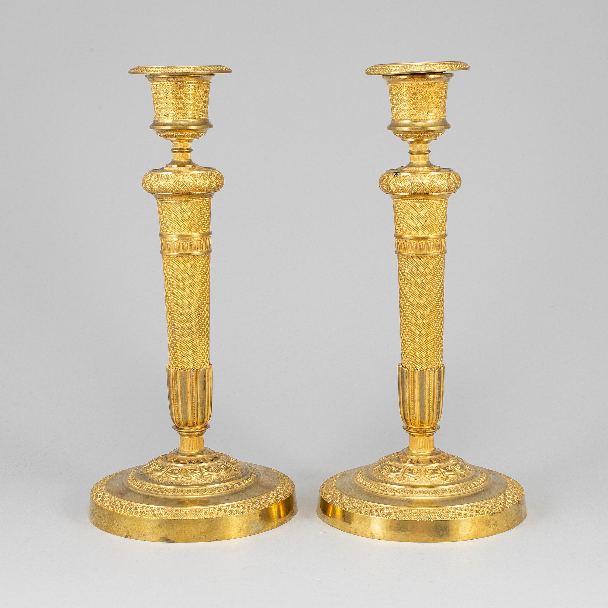 A pair of ormolu candlesticks, first half of the 19th century.