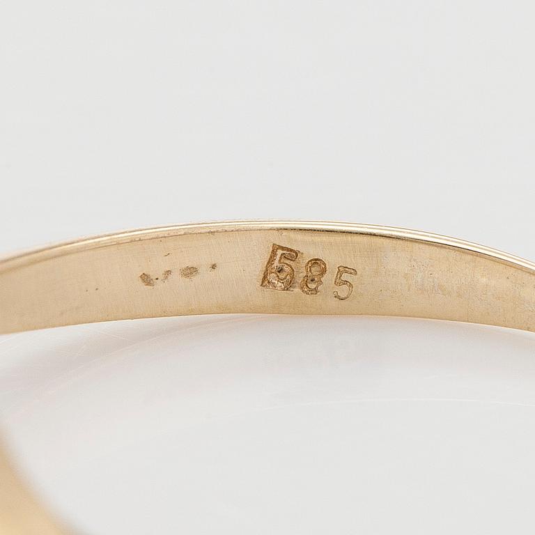 A 14K gold ring with brilliant cut diamond.