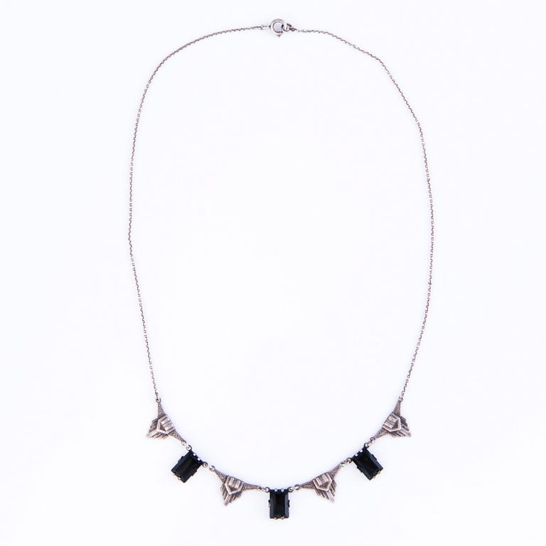 Four Art deco jewelry, ring, pendant necklace and earrings in silver.