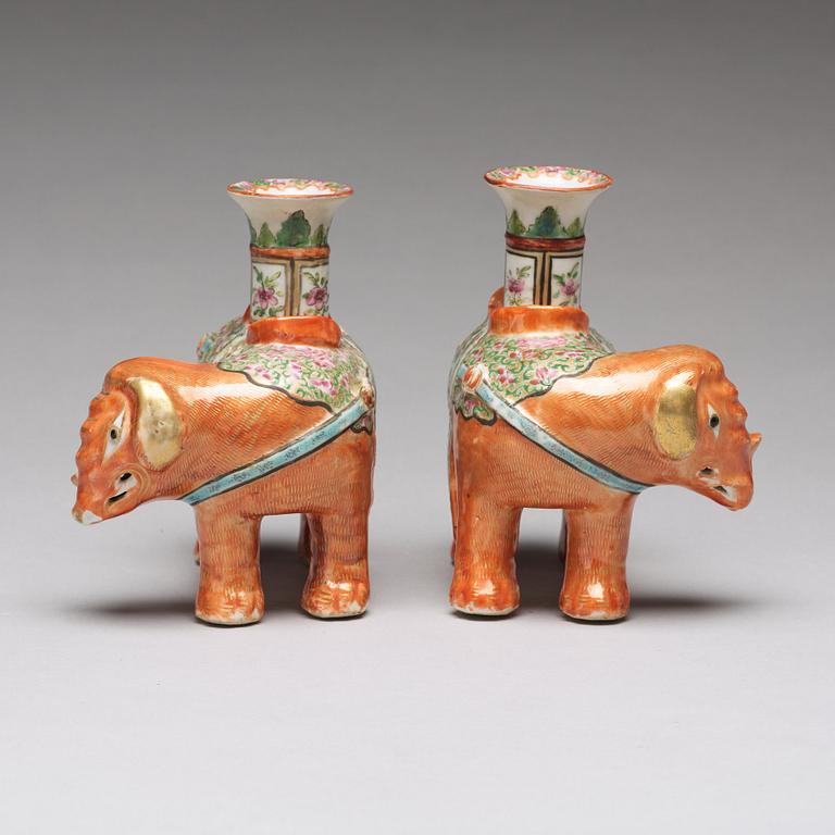 A pair of famille rose Canton elephant candle holders, late Qing dynasty, about 1900.