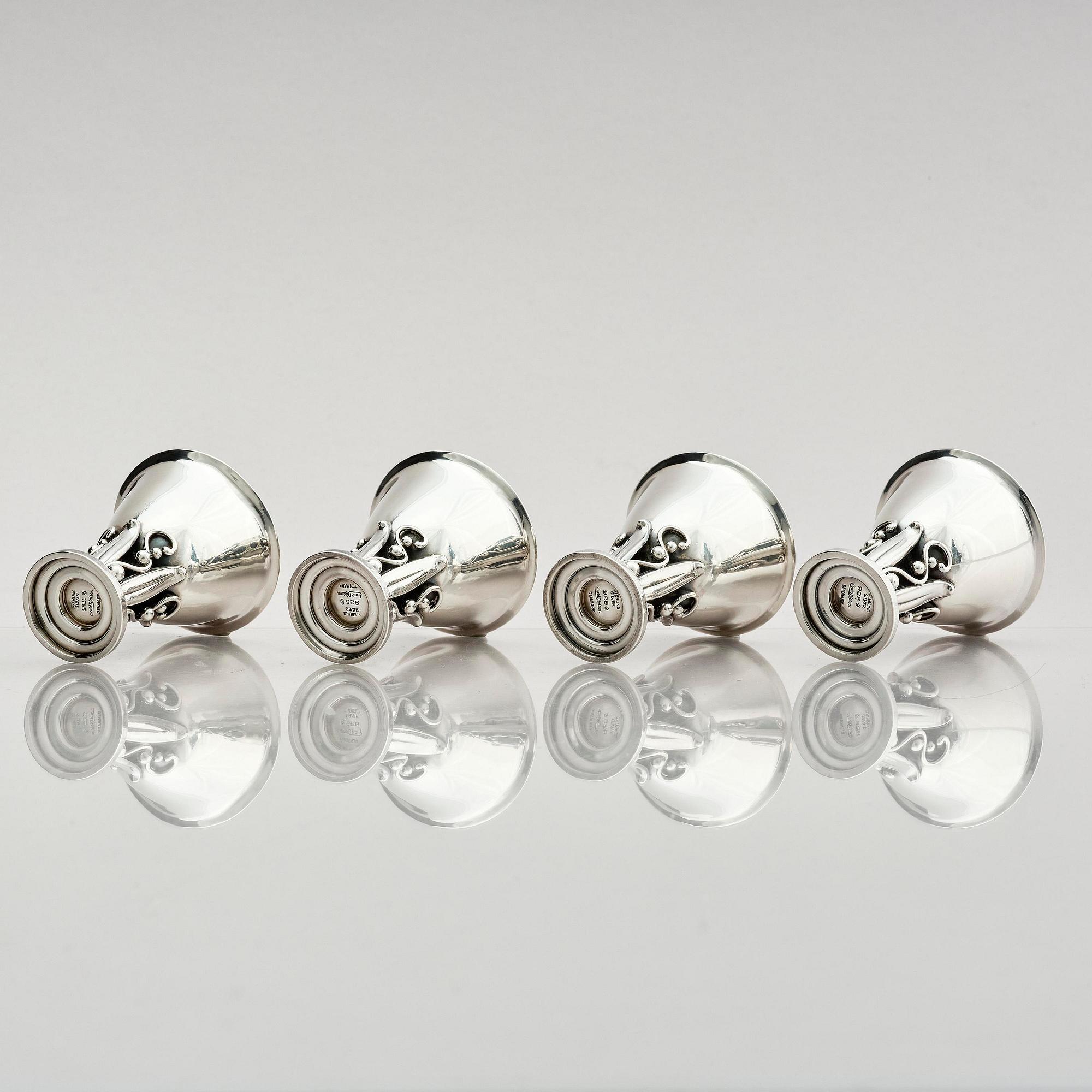 Evald Nielsen, four sterling silver beakers/cups on a foot, Denmark 20th century.