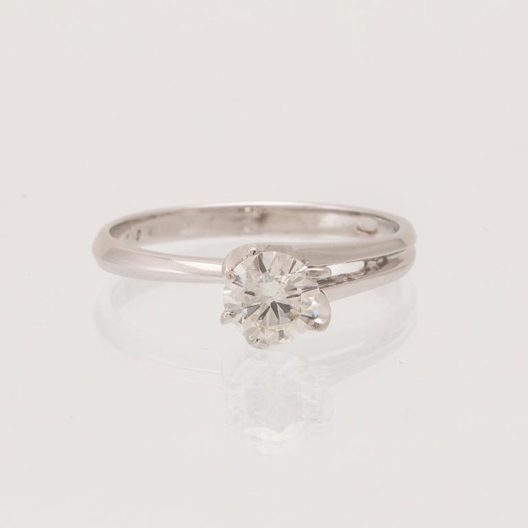 An 18K white gold solitaire ring set with a round brilliant-cut diamond.