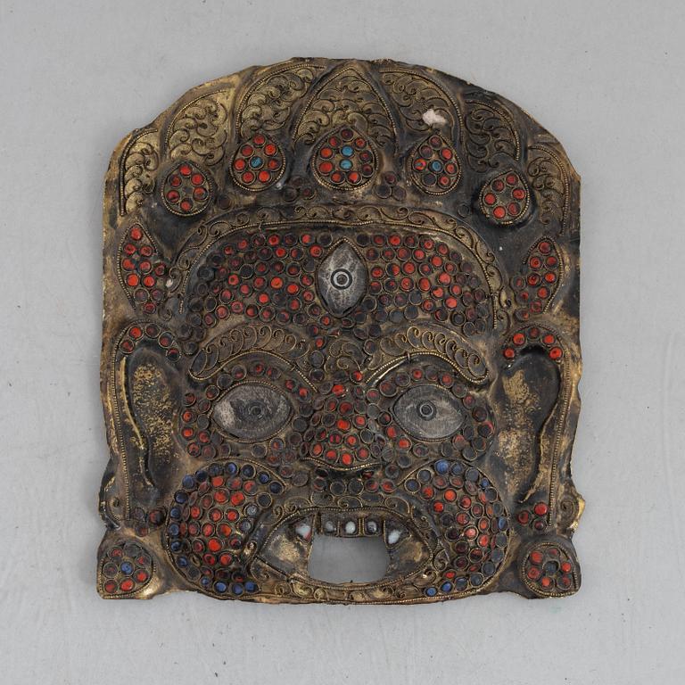 A stone inlay mask, Nepal, early 20th century.