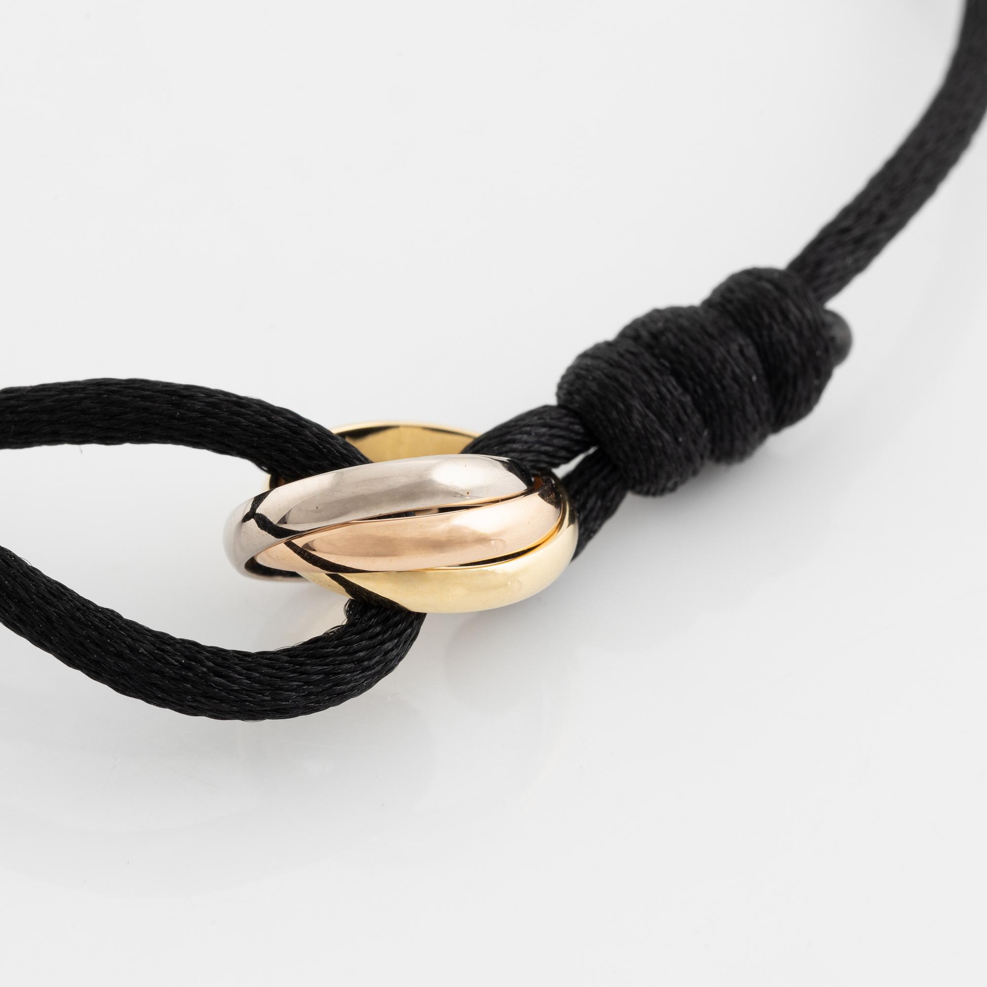 A Cartier "Trinity" bracelet, 18K three colour gold and textile.