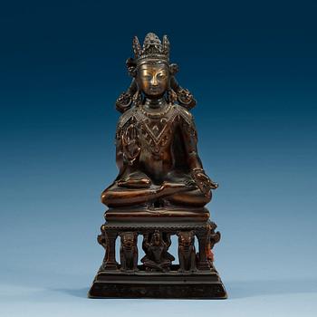 1774. A western Tibetan/Kashmir bronze figure of Maitreya on a high throne, presumably 12th Century or older.
