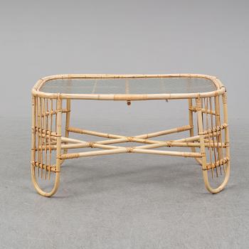 A rattan and glass table and a rattan sofa, second half of the 20th century.