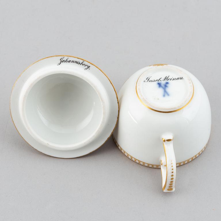 A 19th century Meissen miniature lidded porcelain cup decorated with views of Mainau.