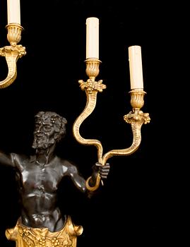 A pair of Louis Philippe 1830/1840's gilt and patinated bronze four-light wall-lights.