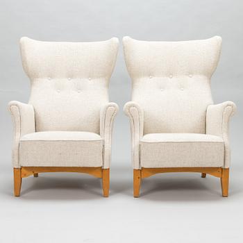 A 1950's pair of 'Inkeri' armchairs manufactured by Asko Finland after a Danish model.