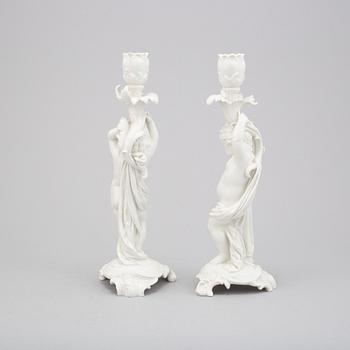 A German white glazed figure group and a pair of Berlin candle sticks, 20th Century.