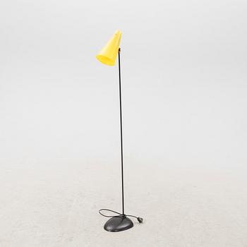 A 1050s metal and plastic floor lamp.