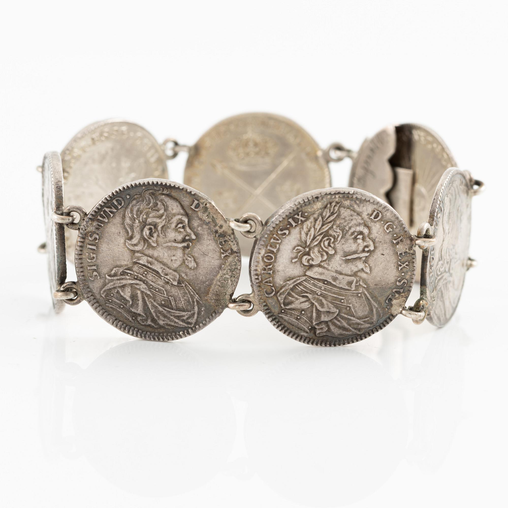 Two bracelets, a brooch, and a pendant with coins.