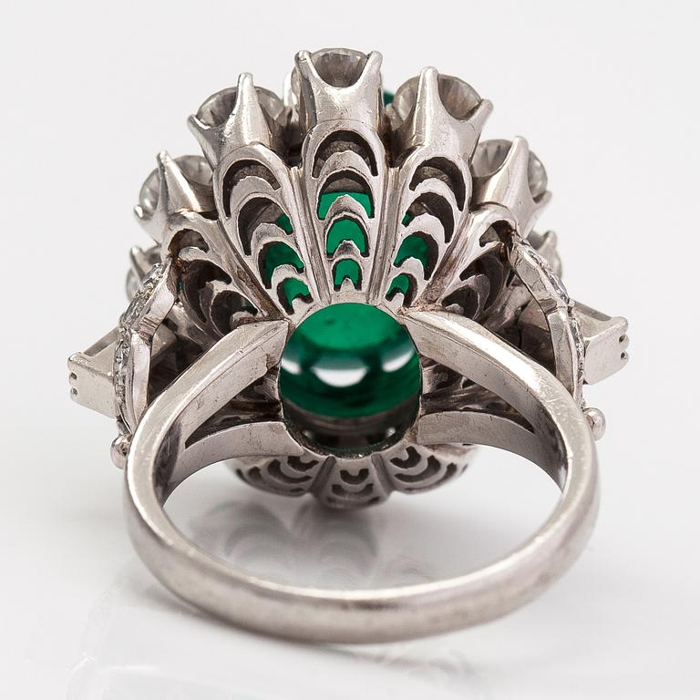 A platinum ring with a ca. 8.50 ct emerald and diamonds ca. 2.84 ct in total. With certificate.