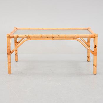 A set of two garden sofas, an armchair and a glass table, later part of the 20th Century.