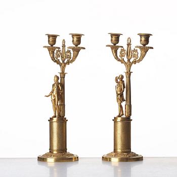 A pair of French Empire two-light gilt bronze candelabra, early 19th century.