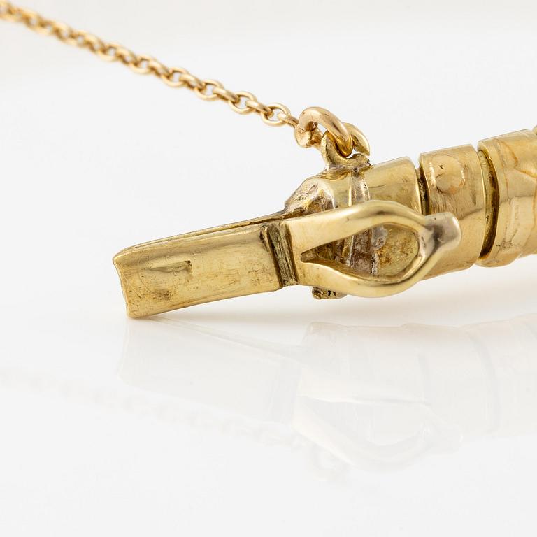 A bracelet in the shape of a serpent in 18K gold with a faceted citrine and rose-cut diamonds.
