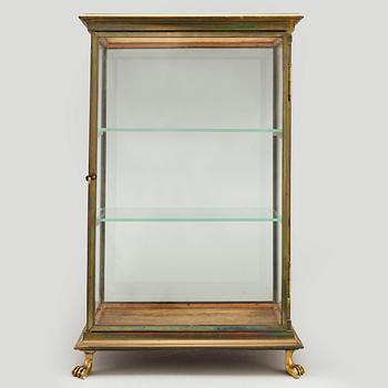 A brass and glass display cabinet, first half of the 20th Century.