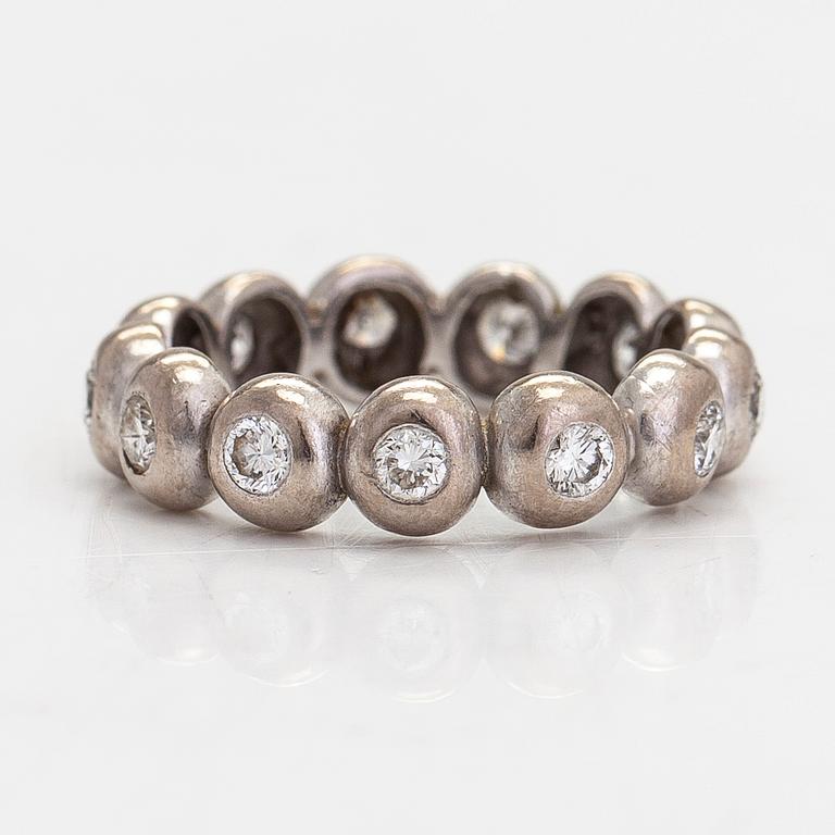 An 18K white gold eternity ring, with brilliant-cut diamonds totalling approximately 0.39 ct.