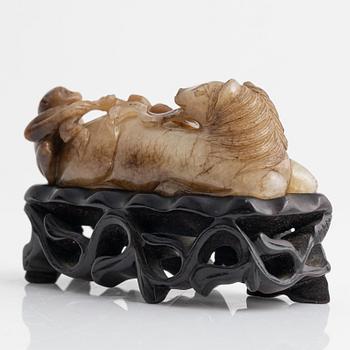 A Chinese sculptured figure of a reclining horse, 20th Century.