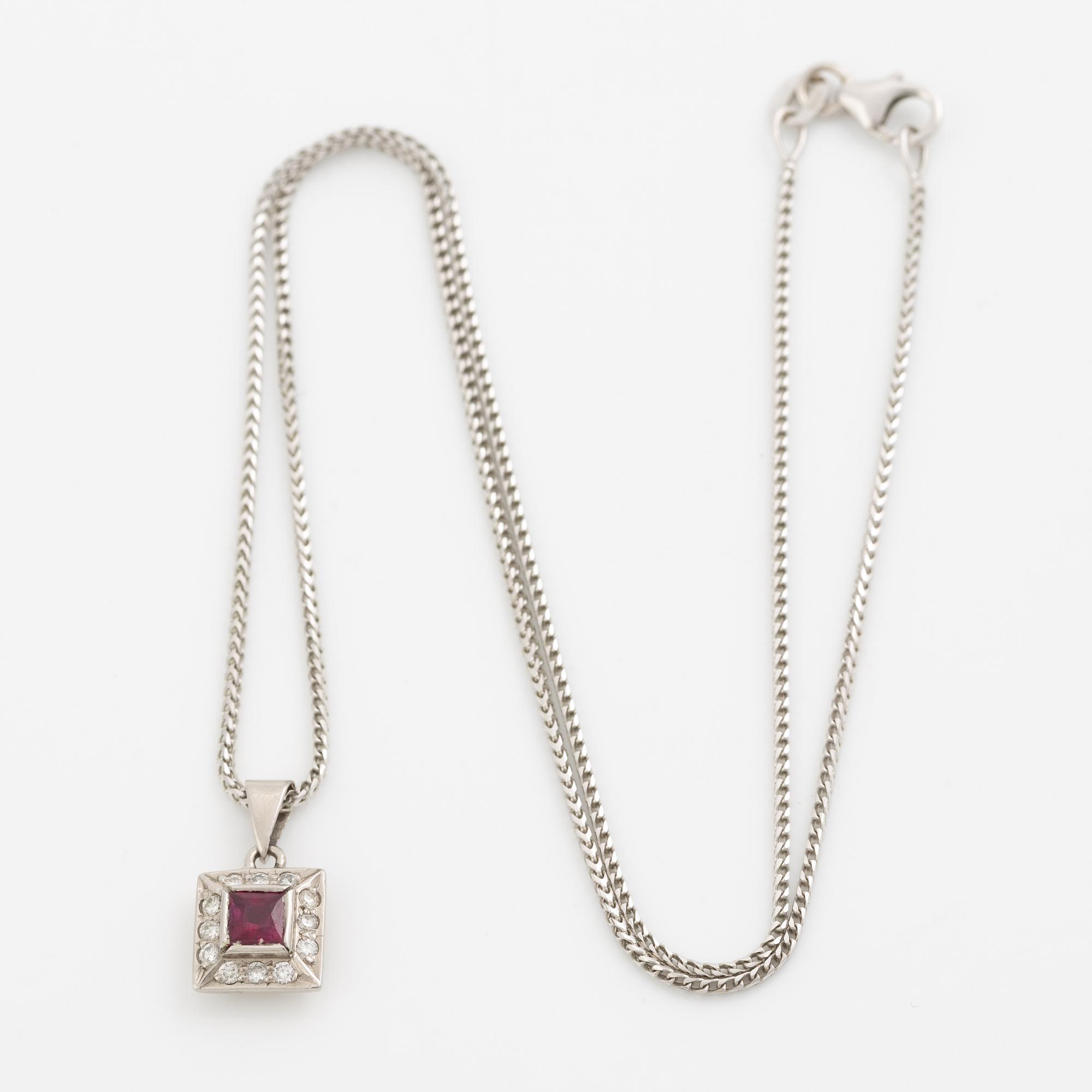 Pendant with chain in 18K white gold featuring a red stone, likely a ruby, and diamonds.
