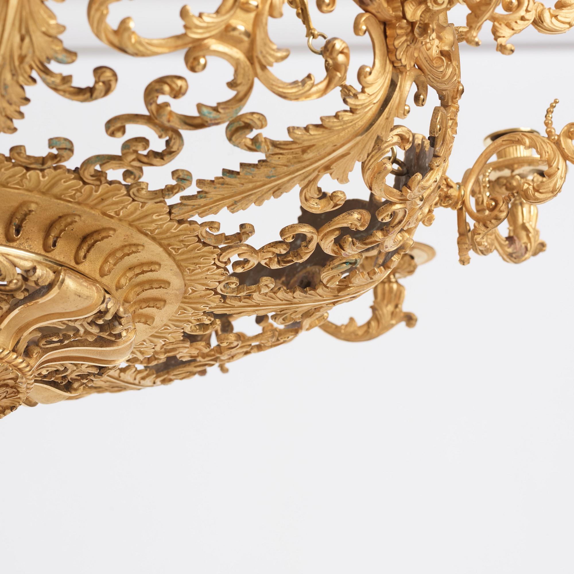 A rococo-revival gilt-brass sixteen-light chandelier, mid 19th century.