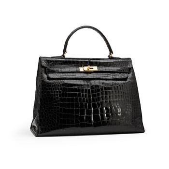 593. HERMÈS, a black crocodile "Kelly 35" bag from the 1960s.
