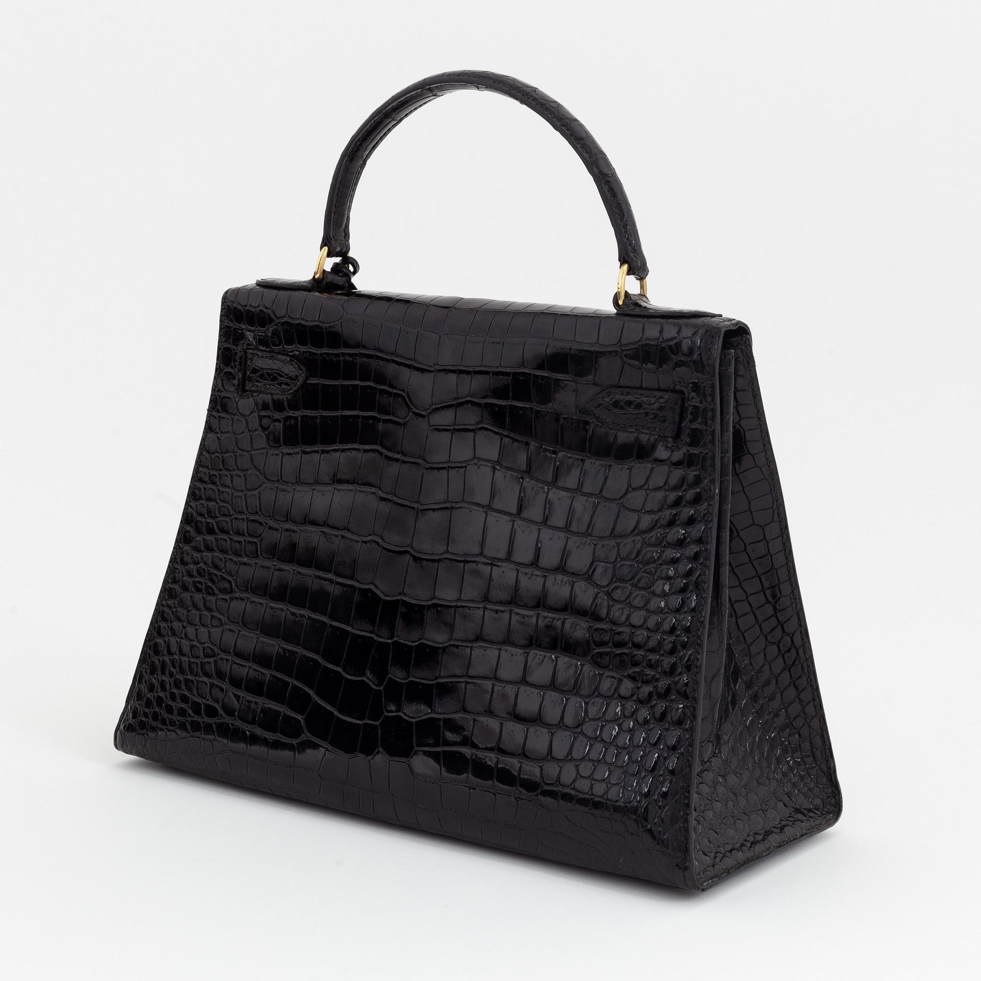 1962 black alligator 'Kelly' handbag by Hermès.