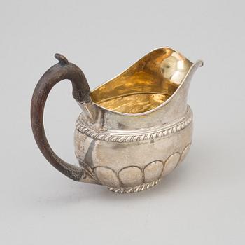 A Russian parcel-gilt cream jug, maker's mark Erik Frisk, St Petersburg, 1826.