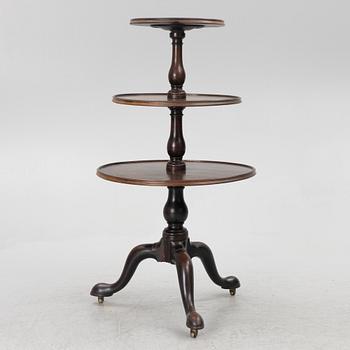 A mahogany three-tier table, England, circa 1900.