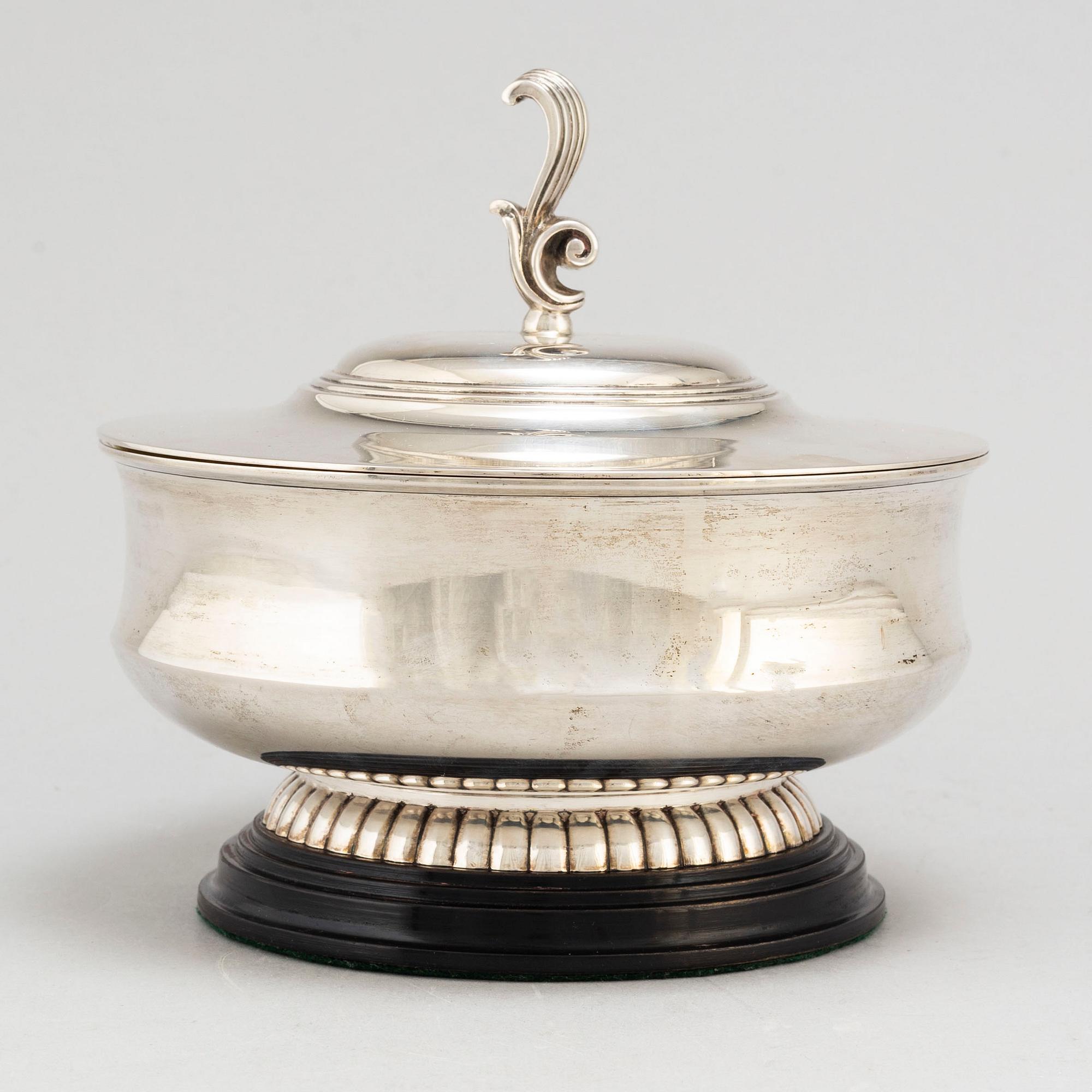 A parcel gilt silver bowl on a wooden base by CG Hallberg Stockholm 1934.