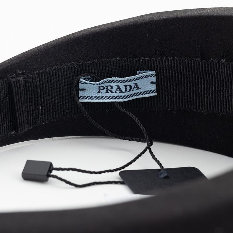 Prada, a black silk hair accessory.