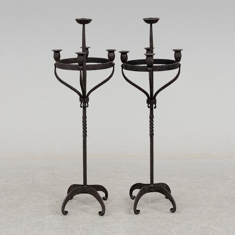 a pair of iron floor candle sticks, 20th century.