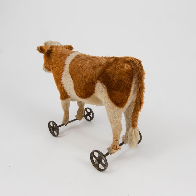 A Steiff cow and a Schuco "Tricky", Germany, 1910 and 1930/40s.