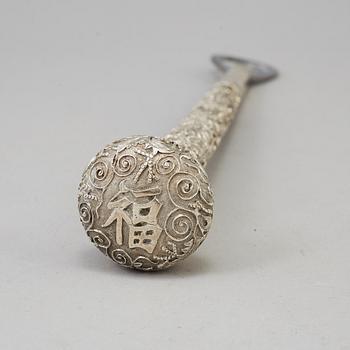 A silver handle for a cane, remodeled in to a can opener, China, 20th Century.