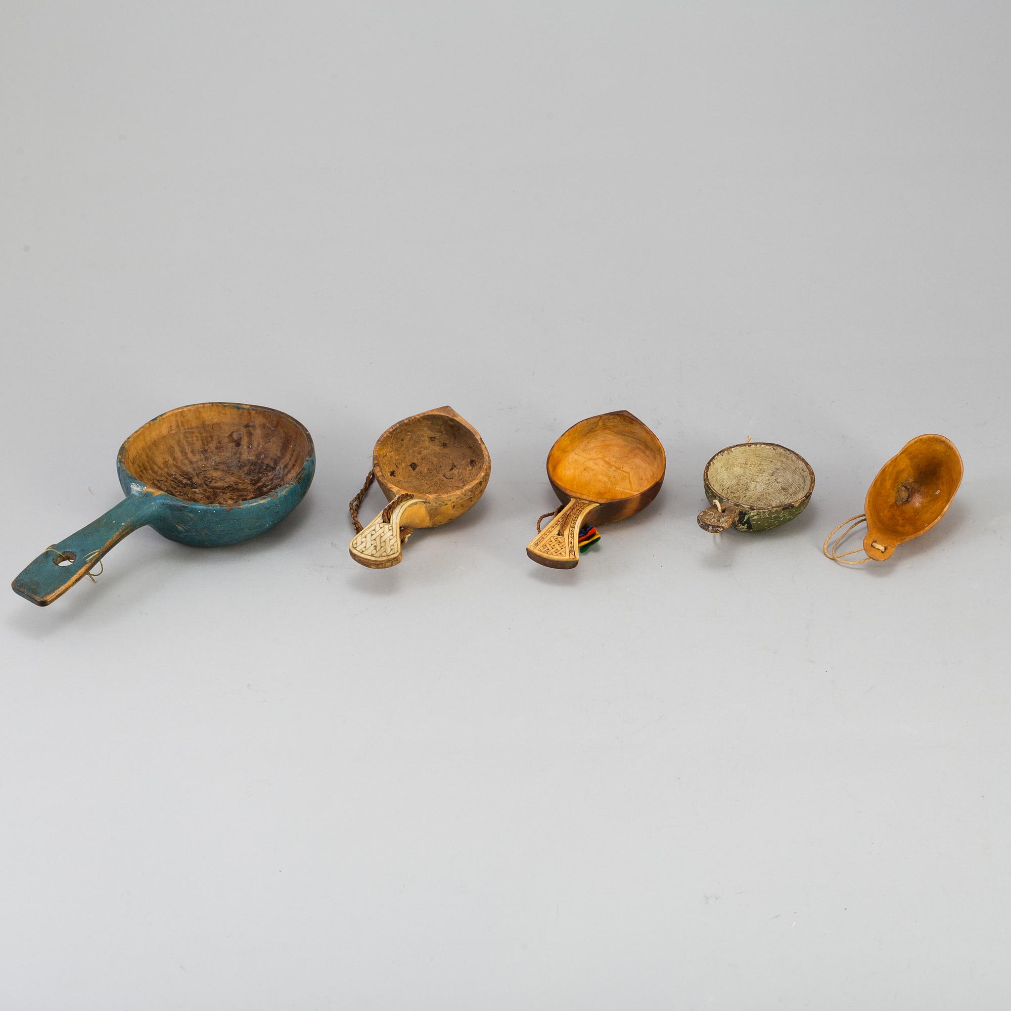 A set of five amongst others Sami cups made of birchwood and reindeer antlers.
