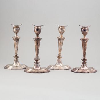 A set of four English 19th century silver-plated candlesticks.