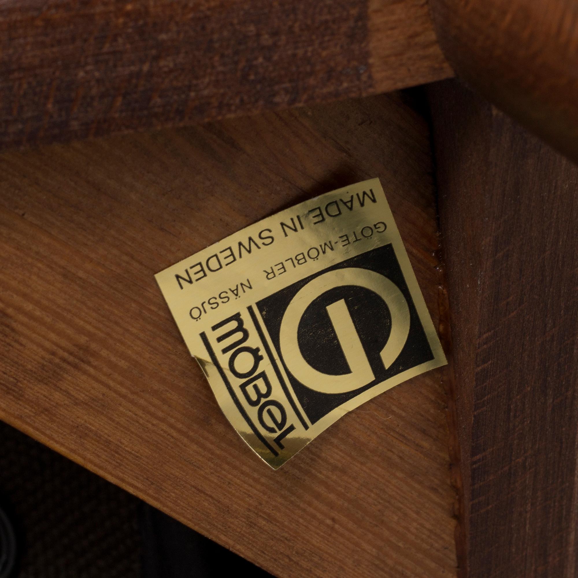 A pair of stained beech and leather easy chairs from Göte Möbler, Nässjö, second half of the 20th century.