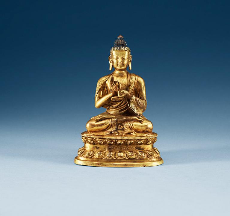 A gilt copper Buddha, presumably Qing dynasty, with Qian Long seven character mark.