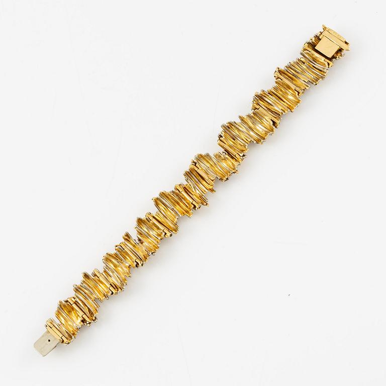 An 18K gold bracelet set with round brilliant-cut diamonds and cabochon-cut sapphires.