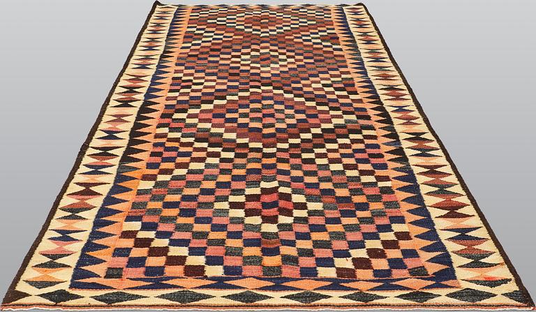 A kilim carpet, ca 333 x 163 cm.